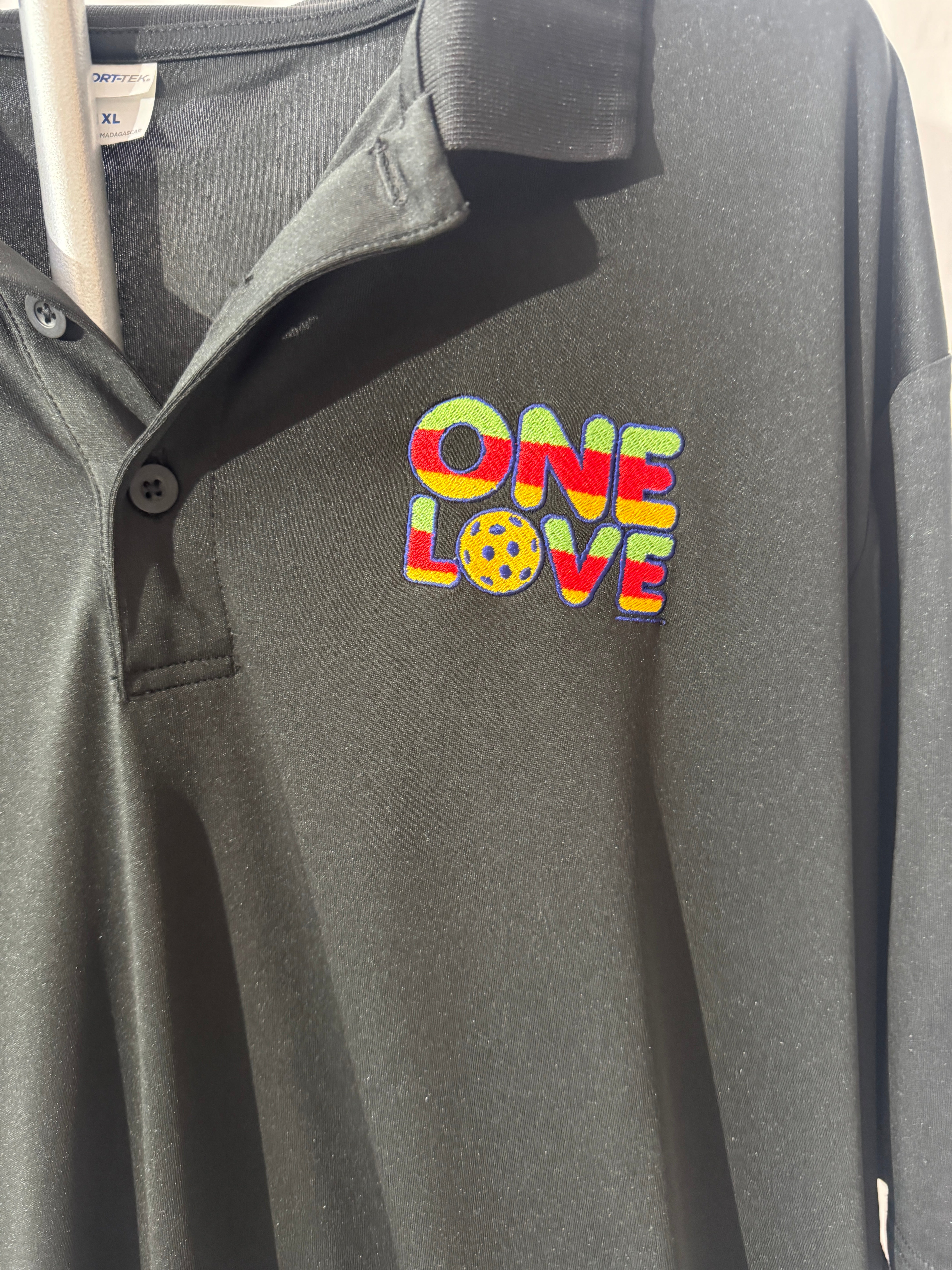 Gray bag with 'One Love' text and peace symbol on a plain background