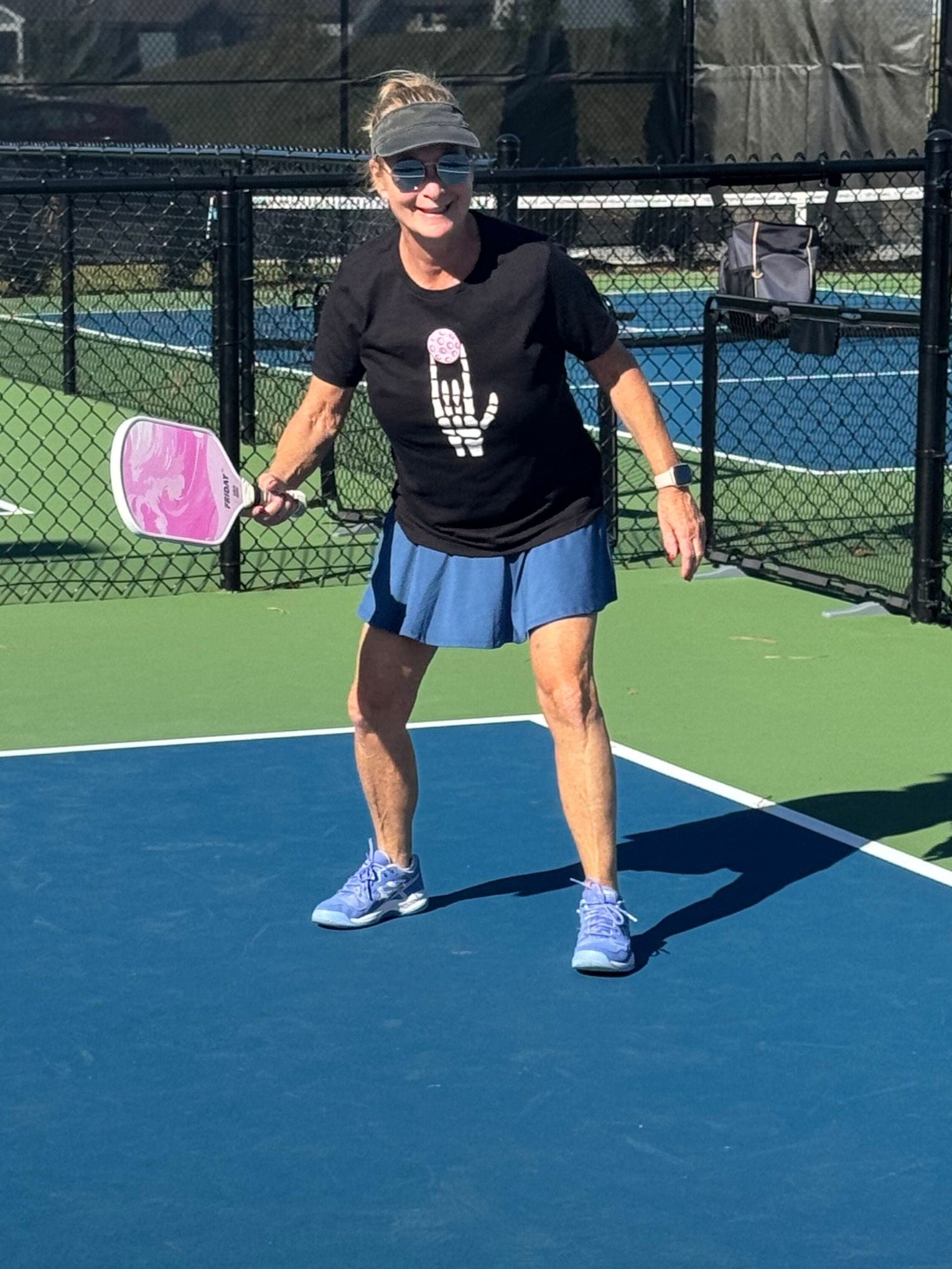 Person playing paddleball on a court with a racket